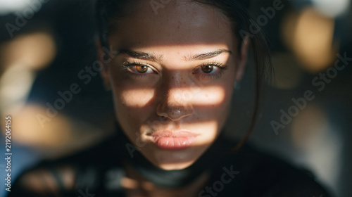 Dramatic Portrait of Serious Young Woman in Shadows