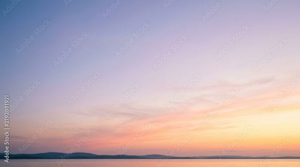 Obraz premium Serene sky gradient shifting from cool blue and lilac to warm peach and yellow, minimalist atmospheric background, soft dawn light, smooth color transitions, calm wellness and presentation aesthetic
