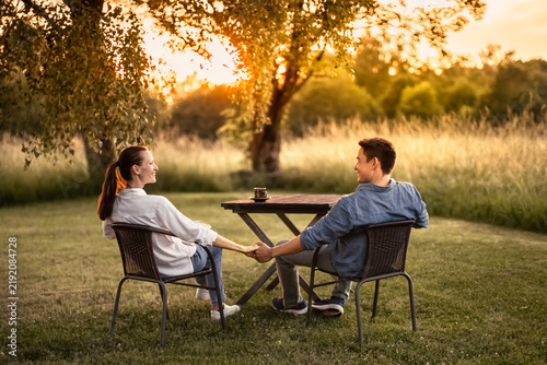Happy Couple Holding Hands Outdoors at Sunset, Love, Connection and Lasting Relationship Concept
