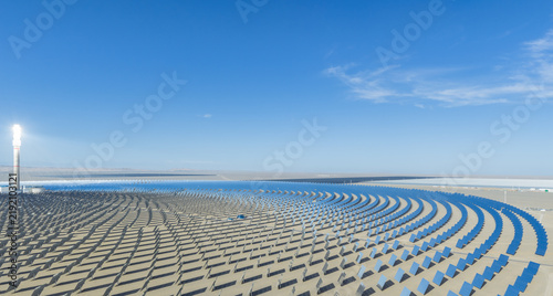 Aerial View of Molten Salt Concentrated Solar Power Plant with Glowing Receiver Tower and Vast Heliostat Mirror Array in Gobi Desert