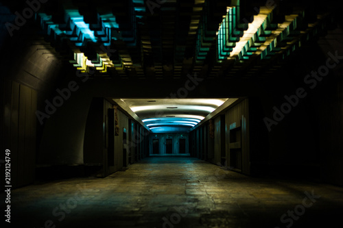 Принти на полотні Dark corridor with geometric blue and warm ceiling lights