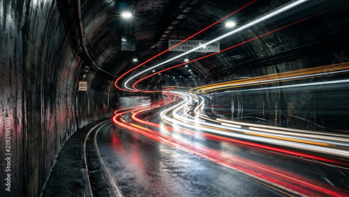 Dynamic Red and White Traffic Light Trails in Urban Road Tunnel at Night