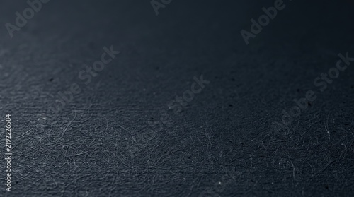 Dark textured paper surface with visible fibrous details and matte finish for professional artistic backgrounds and minimalist design