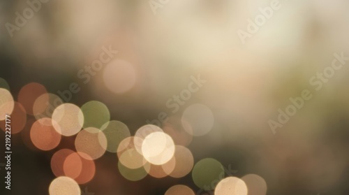 Soft out of focus bokeh lights glowing in warm tones against a dark blurred background for festive atmosphere