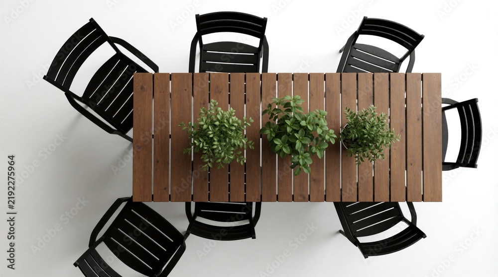 Fototapeta premium Top view of wooden outdoor dining table with black chairs and potted plants. Furniture set on white background, simple clean design for patio or garden.