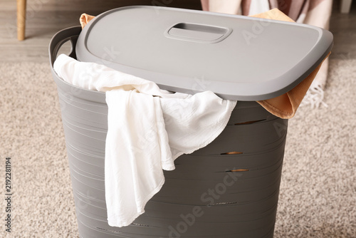 Cuadro en lienzo Household chores and laundry organization, grey plastic hamper with dirty clothe