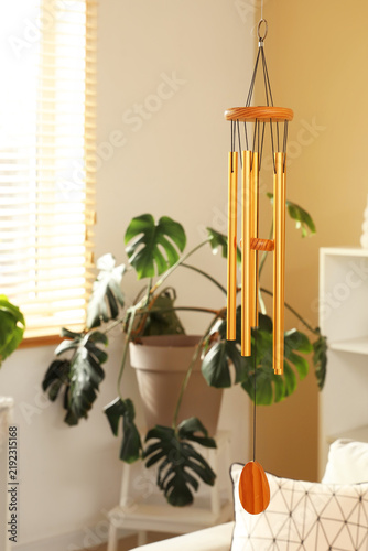 Fotografie Wind chime hanging in light living room, closeup