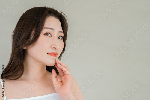 Fotografie Woman in Her 40s and 50s Touching Her Jawline, Aging Care and Beautiful Skin Bea
