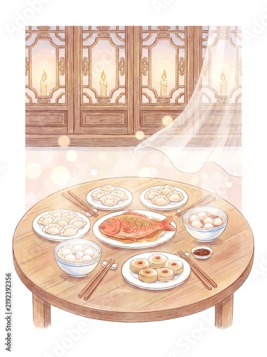 Traditional dishes arranged on a round table with chopsticks and tea