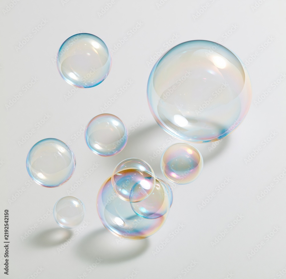 Obraz premium Colorful soap bubbles floating against a white background