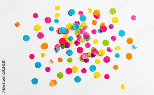 Colorful confetti scattered on white background