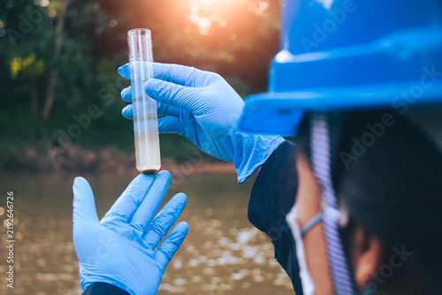 Environmental officials performing water sampling to identify chemical abnormalities and potential pollution.