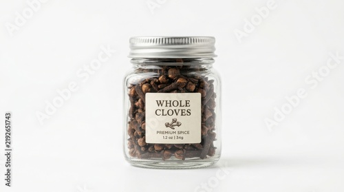 Glass jar filled with whole dried cloves and a label on a white background spice jar dried spices kitchen ingredient food flavoring aromatic spice cooking supply pantry staples organic cloves