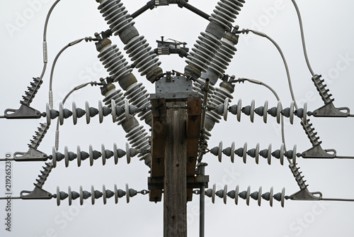 Rows of Porcelain Disc Insulators Beneath Overhead Electrical Switchgear, Low Angle View