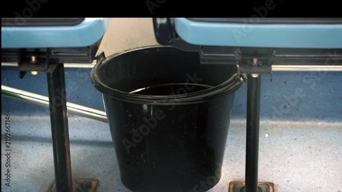Moving water surface in a bucket on a moving city bus floor