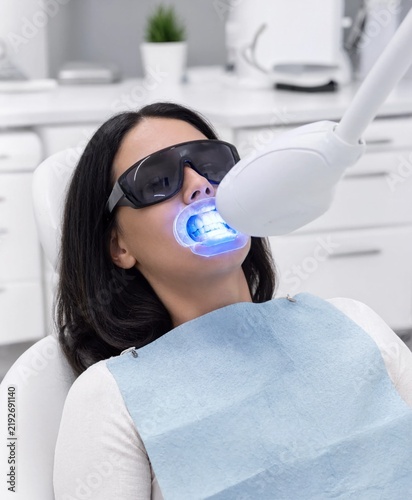 Female Patient Receiving Blue Light Teeth Whitening Treatment