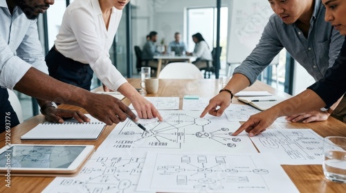 Business team collaborating on network architecture diagrams in office