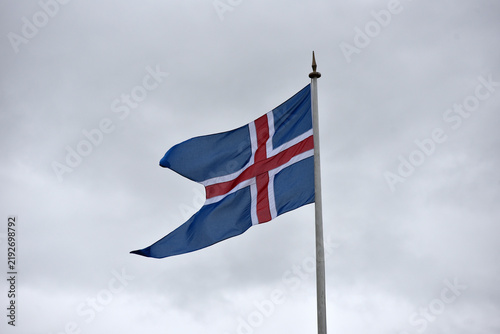 Obraz na plátně National flag of Iceland against a cloudy sky