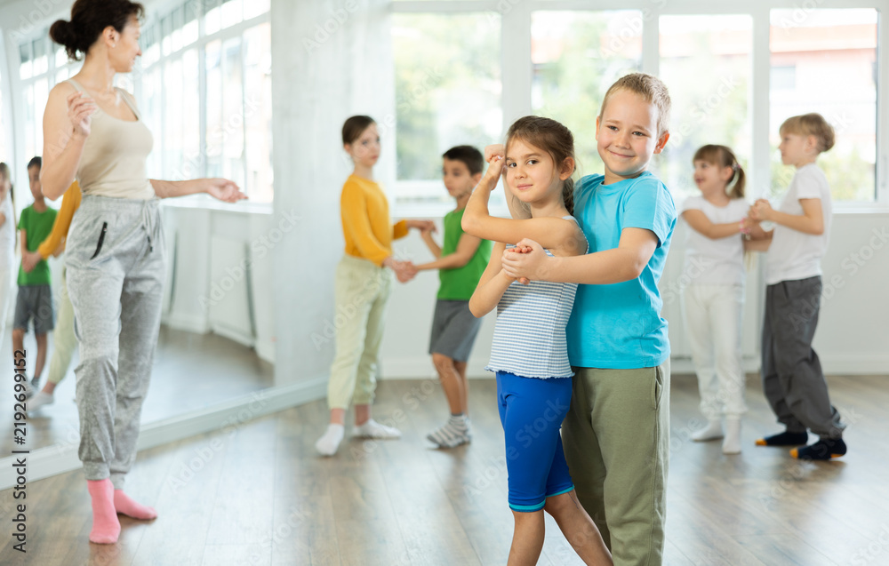 Fototapeta premium Couple boy and girl rehearsing pair waltz dance in studio