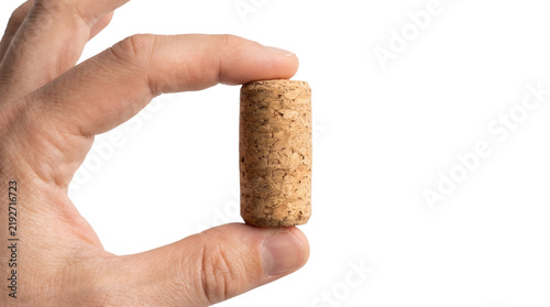 Macro close up of human fingers holding a cylindrical natural wood wine cork stopper mockup isolated on transparent background.