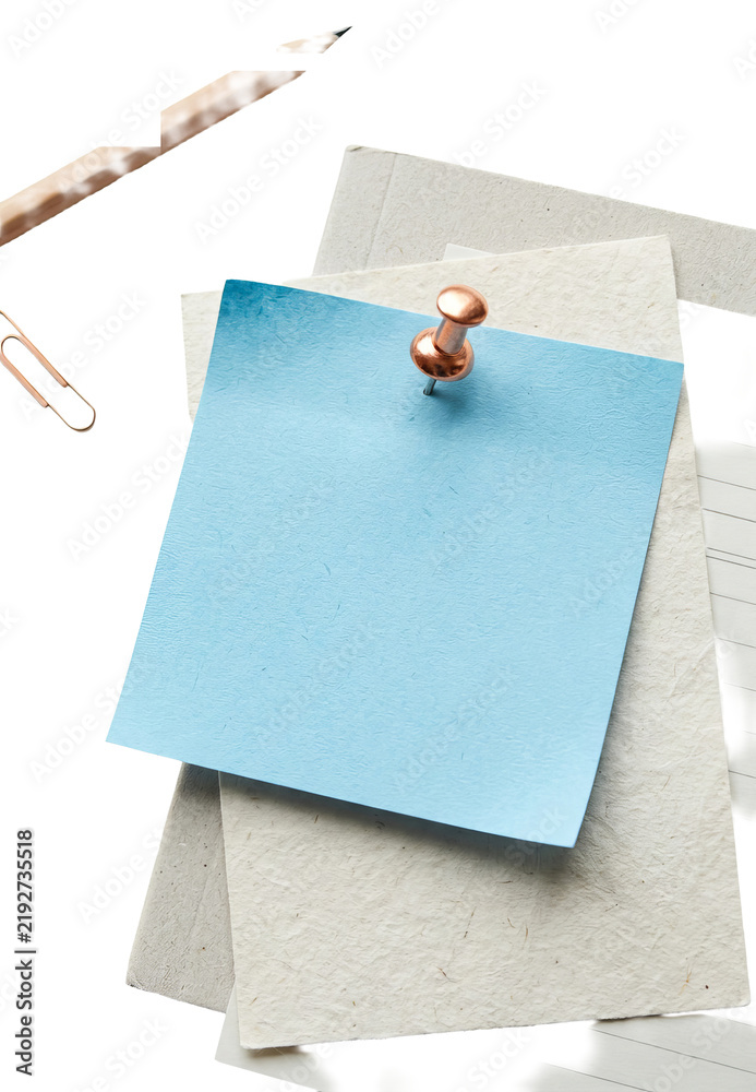 Fototapeta premium Blue sticky note pinned on paper layers.