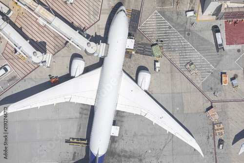Aerial top down view of airplane at airport gate