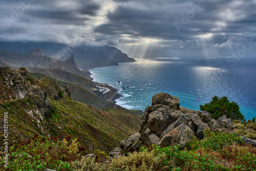 Sunbeams over rugged coastline in Anaga Tenerife