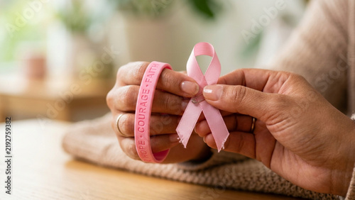 Pink ribbon symbol representing breast cancer awareness and support for patients.