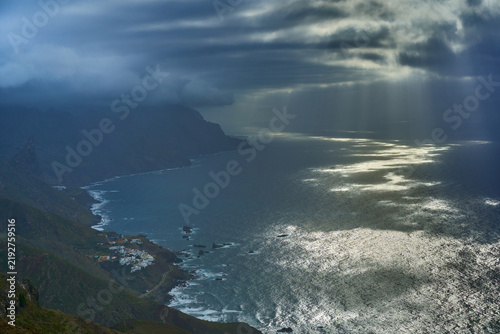 Sunbeams over rugged coastline in Anaga Tenerife