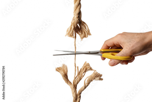 Foto Hand Cutting the Last Strand of a Frayed Rope