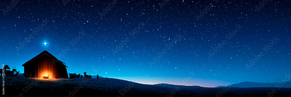 Obraz premium Nativity Scene Under Starry Night Sky with Glowing Stable