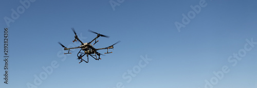 Agricultural technology smart farm concept. Farmer technicians remotely fly agricultural drones to fly to spray fertilizer in fields.