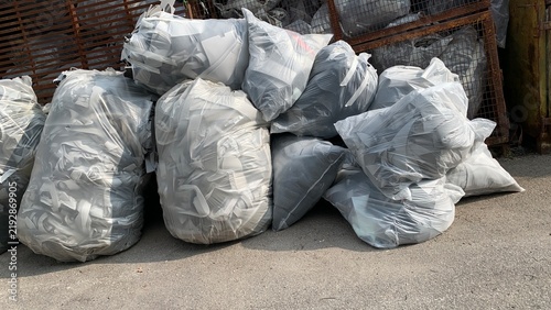 Large bags filled with foam offcuts and production scrap awaiting recycling, disposal, or material recovery processing
