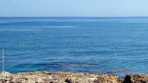 Video of the rocky shore of Crete Island with blue clear Mediterranean sea water. Greece