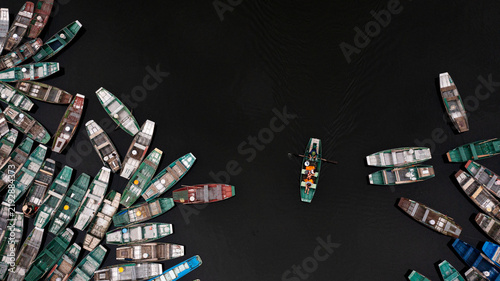 Foto Colorful Boats on a Dark River