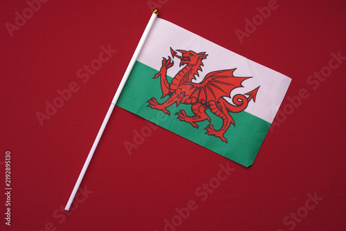 Bild auf Leinwand Small Welsh flag isolated on a red background.