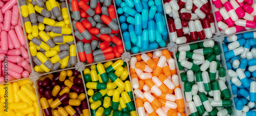 Konstfotografi Assorted colorful medicine capsules organized in separate compartments, pharmaceutical healthcare concept for pharmacy inventory, medication sorting, drug production and medical supply management