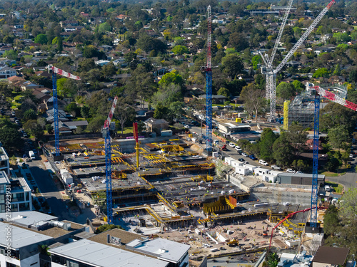 Fotografie Expanding residential construction precinct with tower cranes, concrete floor pl