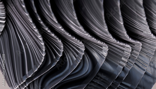 Abstract wavy black metal sculpture with reflective curved surfaces