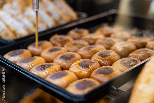 Картината върху платно Traditional Greek syrupy pastries with cocoa filling sit arranged on a tray in Kerkira, Greece
