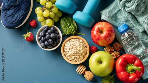 Healthy lifestyle flat lay with fruits, vegetables, and fitness gear. Promoting wellness and active living.