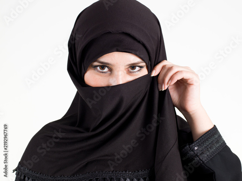 Принти на полотні Close up portrait of Muslim woman wearing black niqab and hijab isolated on white background