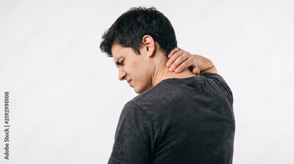 Fototapeta premium Young man suffering from neck pain and muscle strain isolated on white background