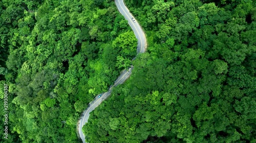 Road in the middle of the forest , road curve construction up to mountain, Rainforest ecosystem and healthy environment concept