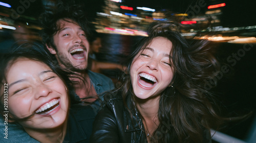 Carefree Young Friends Laughing Together on Night Out