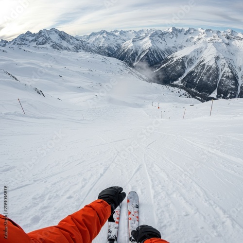 Skiing Down Snowy Mountain Slope with Alpine Peaks in View, Winter Sports Adventure, Panoramic Ski Resort Landscape