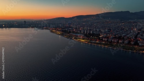 Aerial View of Bostanli Coastline and Izmir Cityscape at Orange Sunset Dusk Turkey
