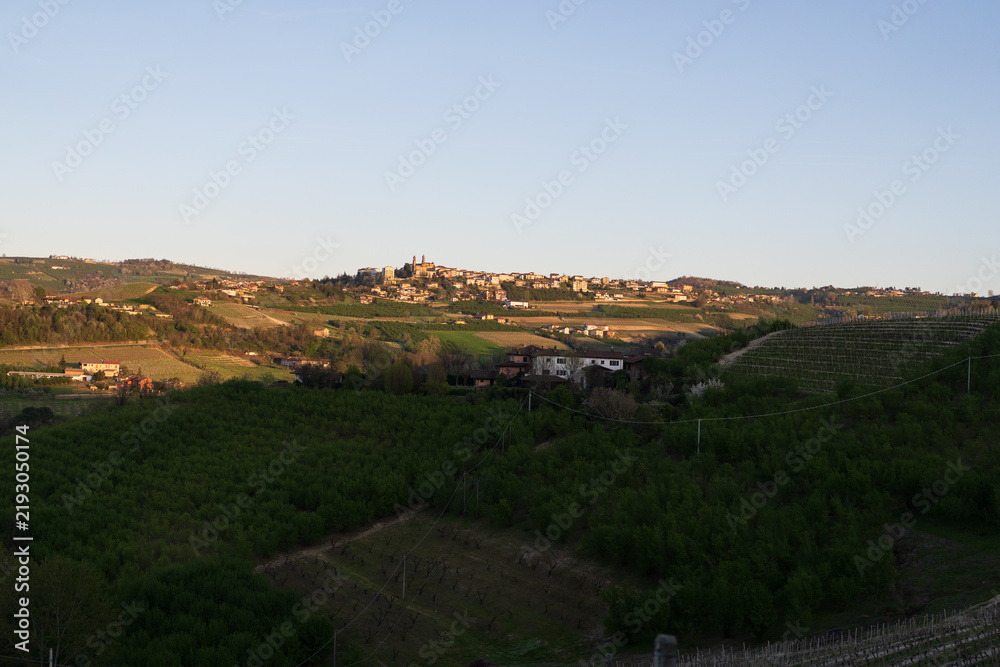 Obraz premium Langhe Vineyards and Hilltop Village at Sunset
