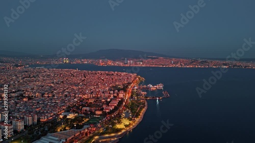High Angle Aerial View of Izmir Bay and Bostanli Cityscape at Dusk Nightfall Turkey