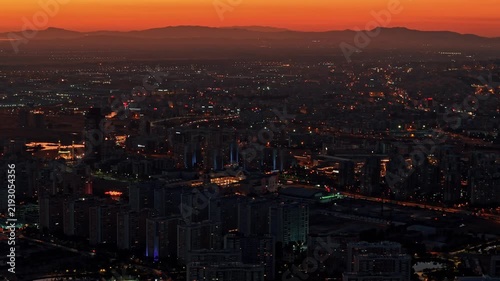 Aerial View of Izmir Cityscape at Vivid Orange Sunset Dusk with Glowing City Lights